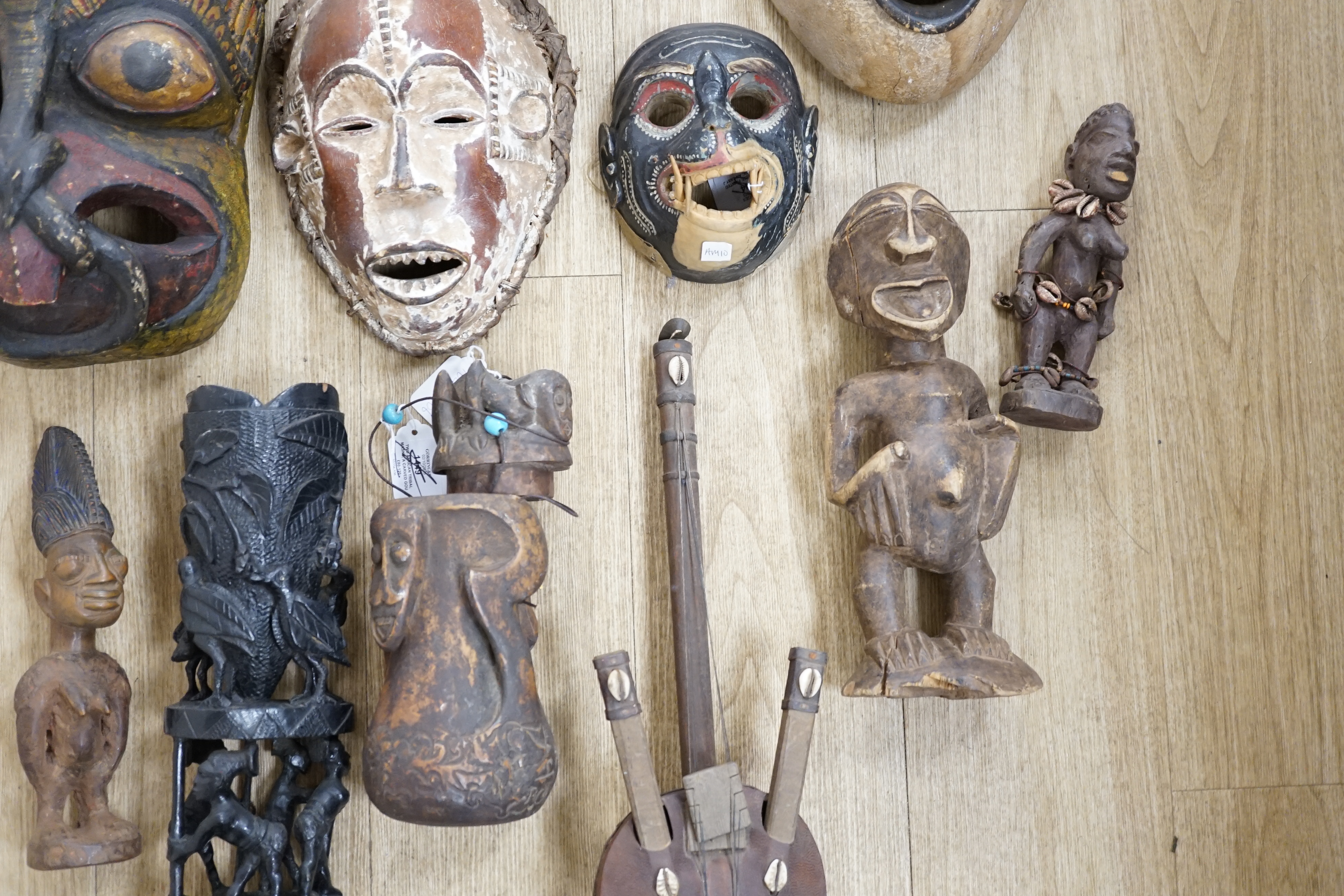 Eight Yoruba carved wood tribal figures and a terracotta vessel (9), largest 35cm high